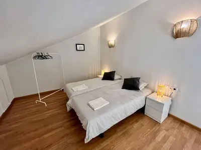 a bedroom with two beds with white sheets at Apartamento espacioso y familiar in Terrassa