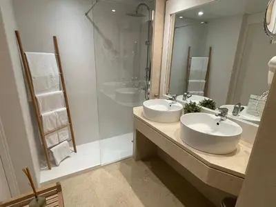 a bathroom with two sinks and a shower at Mediterraneo Sitges in Sitges