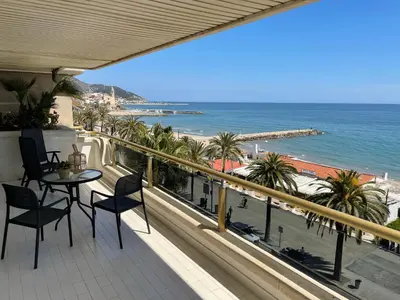 a balcony with a table and chairs and the ocean at Mediterraneo Sitges in Sitges