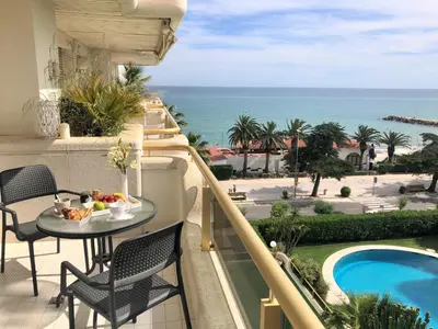 a balcony with a table and a view of the ocean at Mediterraneo Sitges in Sitges