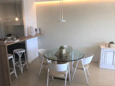 a dining room with a glass table and chairs at Mediterraneo Sitges in Sitges