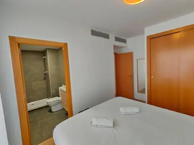 a room with a bed and a bathroom with a toilet at Large terrace luxury apartment in Sant Adria de Besos