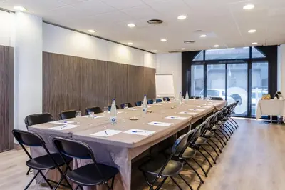 a conference room with a long table and chairs at Hotel HC*** Mollet Barcelona in Mollet del Vallès