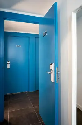 a pair of blue doors in a room at Hotel 54 Barceloneta in Barcelona