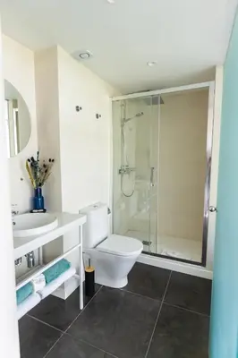 a bathroom with a toilet and a sink and a shower at Hotel 54 Barceloneta in Barcelona