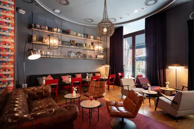 a restaurant with a leather couch and tables and chairs at Chic & Basic Born Boutique Hotel in Barcelona