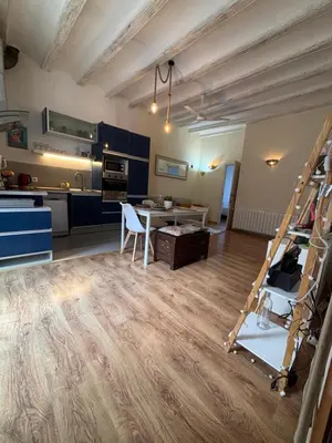 a kitchen and a living room with a ladder at MODERN FLAT POBLE NOU in Barcelona