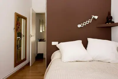 a bedroom with a bed with two white pillows at MODERN FLAT POBLE NOU in Barcelona