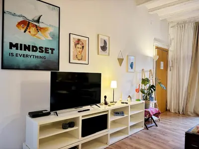 a living room with a flat screen tv on a wall at MODERN FLAT POBLE NOU in Barcelona