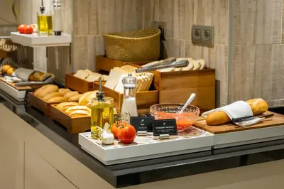 a buffet with bread and other foods on a table at Hotel Santa Marta in Barcelona