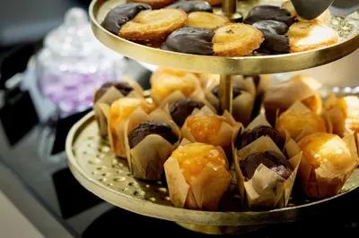 a bunch of different pastries on three tiered plates at Hotel Santa Marta in Barcelona