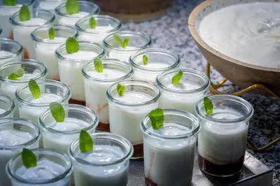 a bunch of jars of milk with mint leaves in them at Hotel Rialto in Barcelona