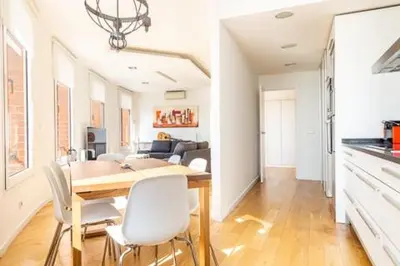 a kitchen and dining room with a table and chairs at Idyllic apartment in BCN beach in Barcelona