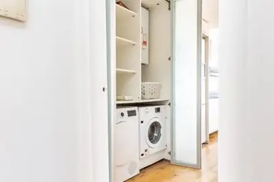 a laundry room with a washer and a washing machine at Idyllic apartment in BCN beach in Barcelona