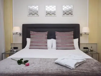 a bedroom with a white bed with two pillows at Vilana Hotel Boutique in Barcelona