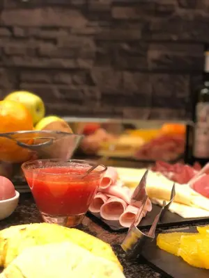 a table topped with fruits and vegetables andacersacersbestosbestosbestosbestosbestosbestos at Vilana Hotel Boutique in Barcelona