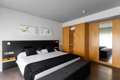 a bedroom with a large bed with a black headboard at Onix Liceo in Barcelona