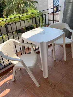a white table and two chairs on a balcony at Galeón in Sitges