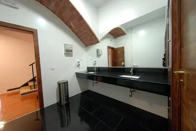 a bathroom with a black sink and a mirror at Galeón in Sitges