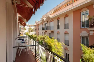 an apartment balcony with a view of a street at El Cid in Sitges