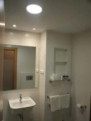 a bathroom with a sink and a mirror at El Cid in Sitges
