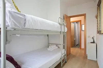 a room with two bunk beds and a hallway at Beautiful apartment in Las Ramblas Barcelona 6pax in Barcelona