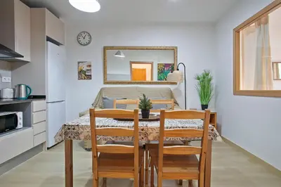 a dining room with a table with chairs and a mirror at Beautiful apartment in Las Ramblas Barcelona 6pax in Barcelona