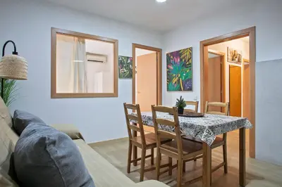 a living room with a table and chairs and a couch at Beautiful apartment in Las Ramblas Barcelona 6pax in Barcelona