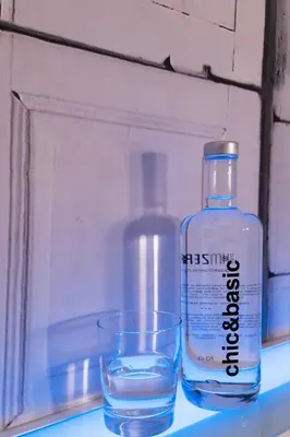 a bottle of water and a glass on a table at Chic & Basic Tallers Hostal in Barcelona