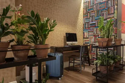 an office with potted plants and a desk with a computer at Praktik Garden in Barcelona