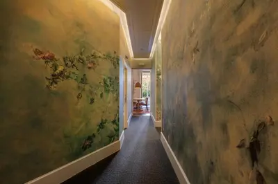 a hallway with a painting on the wall at Praktik Garden in Barcelona