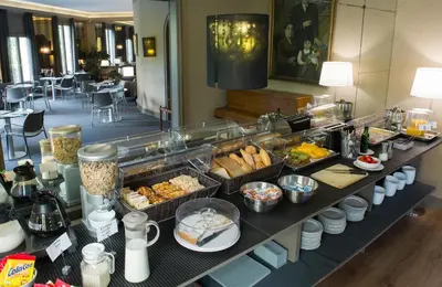 a buffet in a hotel with food on a table at Hotel Paseo de Gracia in Barcelona