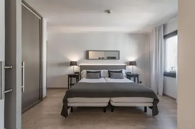 a bedroom with a bed and a mirror on the wall at Hotel Paseo de Gracia in Barcelona