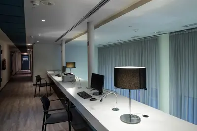 an office with a desk with a computer and chairs at Catalonia Avinyo in Barcelona