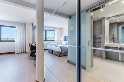 a hotel room with a bed and a desk at Exe Campus in Bellaterra