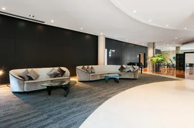 a lobby with two couches and a piano at Exe Campus in Bellaterra