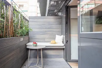 a bedroom with a bed with a hat on it at Aparthotel Bcn Montjuic in Barcelona