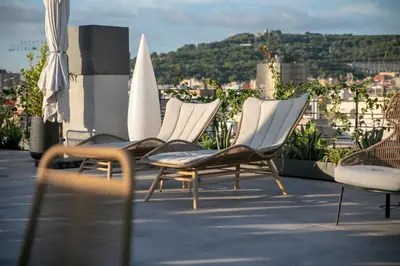 a group of chairs sitting on top of a roof at Silken Ramblas in Barcelona