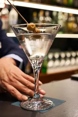 a martini glass with olives on top of a counter at Silken Ramblas in Barcelona