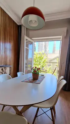 a white dining room table with white chairs and a window at Barcelona4Seasons - Sagrada Familia in Barcelona