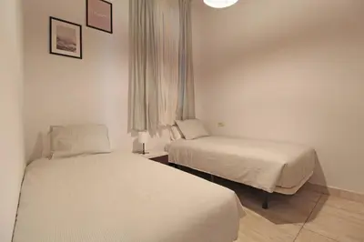 a hotel room with two beds and a window at Paseo de gracia gran vía de les corts catalanes in Barcelona