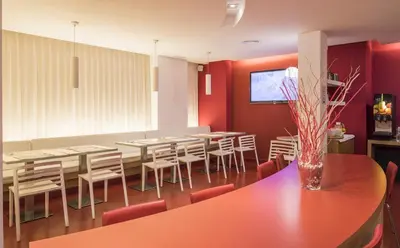 a dining room with red walls and a table and chairs at Ciutat Vella in Barcelona