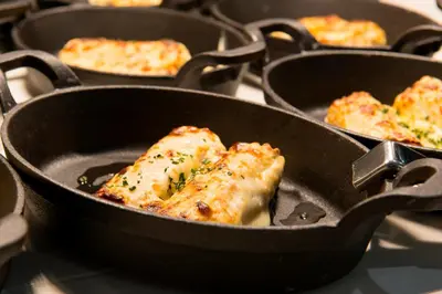 two pans filled with food sitting on a stove at Balneari Termes Victòria in Caldes de Montbui