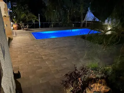 a pool with blue lighting in a yard at night at Costa Maresme Barcelona , Relax & Pool in Cabrils