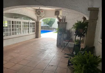 an indoor patio with a pool and an archway with potted plants at Costa Maresme Barcelona , Relax & Pool in Cabrils