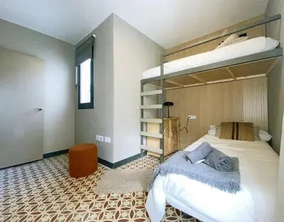 a bedroom with a bunk bed in a room at Fridays Flats Onix House in Hospitalet de Llobregat
