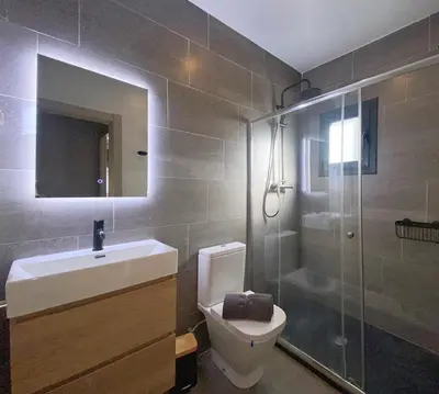 a bathroom with a sink and a toilet and a shower at Fridays Flats Onix House in Hospitalet de Llobregat