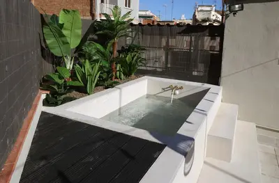 a bath tub sitting on top of a building at Fridays Flats Onix House in Hospitalet de Llobregat