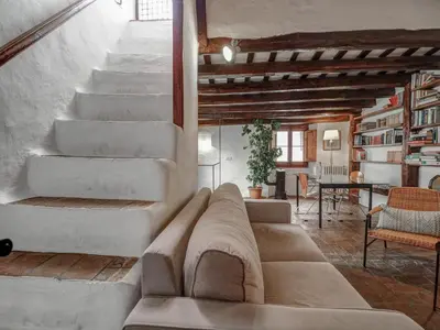 a living room with a couch and a staircase at Beach Villa Aralinn by Hello Homes Sitges in Sitges