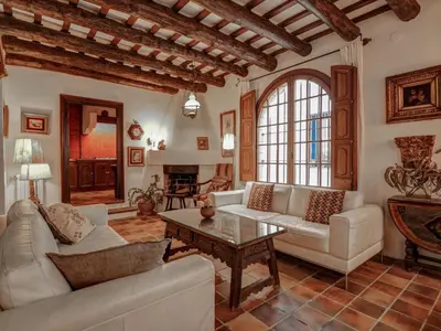 a living room with a couch and a table at Beach Villa Aralinn by Hello Homes Sitges in Sitges